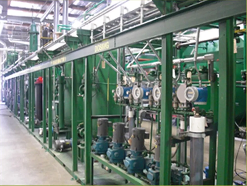 Rows of green steel processing frames, pumps and flow meters inside the GeoGreen Biofuels plant